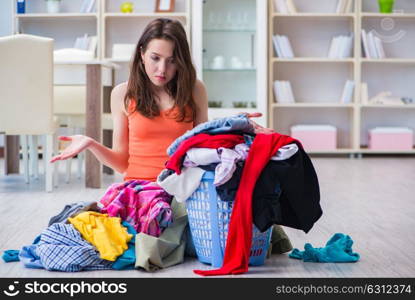 Stressed woman doing laundry at home. The stressed woman doing laundry at home