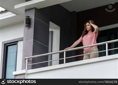 stressed woman quarantine in balcony of her home, coronavirus pandemic concept