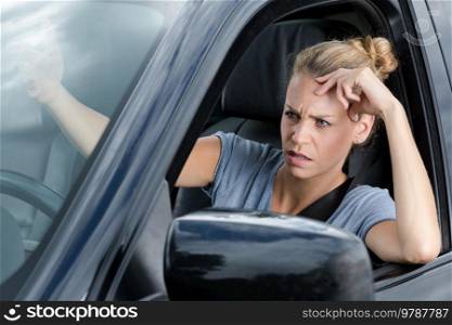 stressed woman upset about traffic in a new car