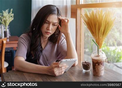 stressed woman using tablet in the cafe