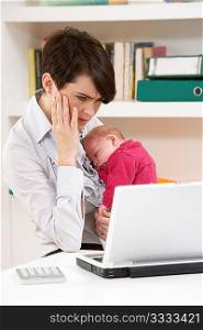 Stressed Woman With Newborn Baby Working From Home Using Laptop