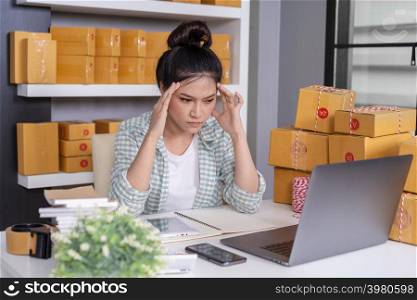 stressed young entrepreneur woman and courier parcel box at home office