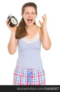 Stressed young woman in pajamas with ringing alarm clock