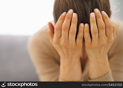 Stressed young woman sitting on couch