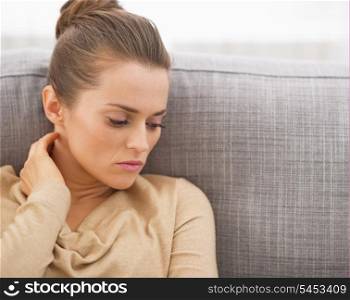 Stressed young woman sitting on couch
