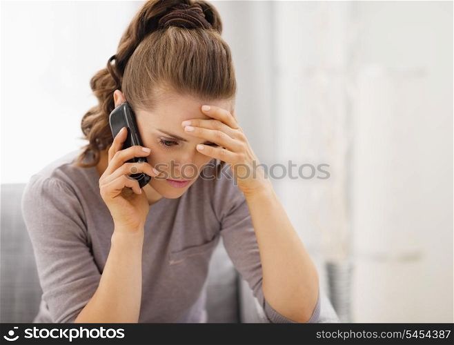 Stressed young woman talking cell phone