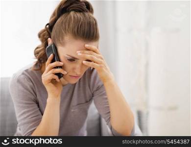 Stressed young woman talking cell phone
