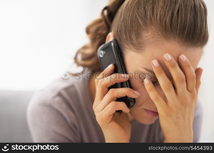 Stressed young woman talking mobile phone