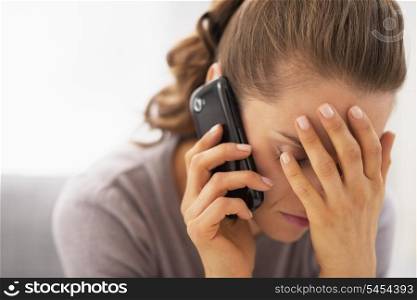 Stressed young woman talking mobile phone