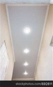 Stretch ceiling in a long narrow corridor