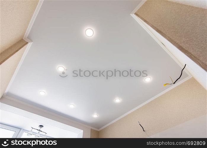 Stretch ceiling in the kitchen with installed and included spotlights