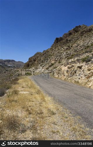 Stretch of bendy road in desert.