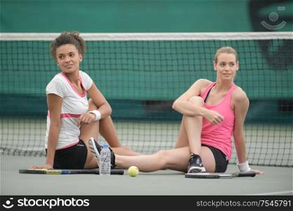 stretching female tennis players warming up