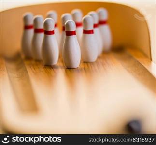 striking ball in a mini bowling wood lane