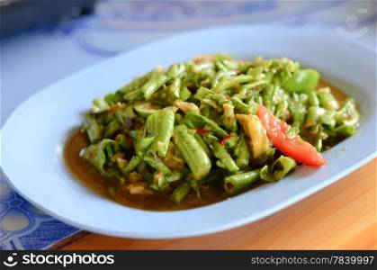 String bean spicy salad on blue dish