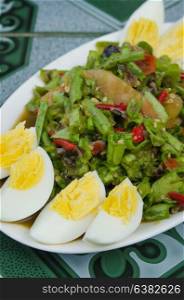 String bean spicy salad on plate served boiled egg