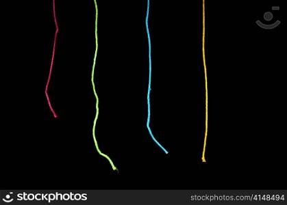 String in various bright colours over black