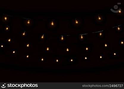 String lights glass bulbs garland with glowing spirals on dark black background
