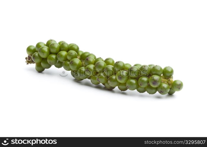 String of fresh unripe green pepper on white background