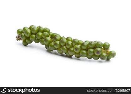 String of fresh unripe green pepper on white background