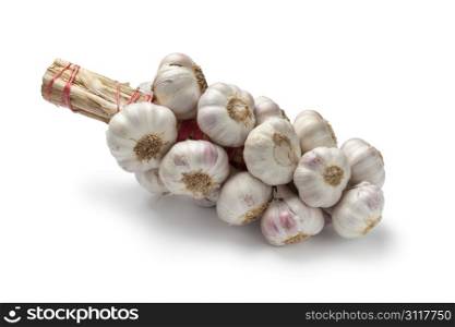 String of garlic bulbs on white background