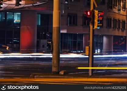strip from passing cars and traffic lights at night street