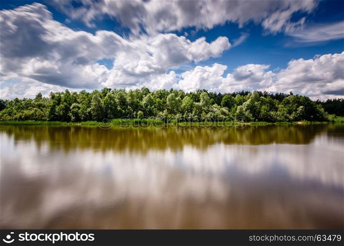Stripe of Forest Between Cloudy Sky and the River near Moscow, View from Coast, Russia