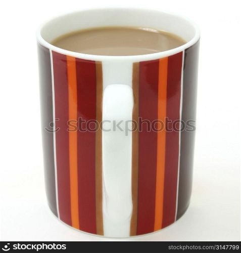 Striped coffee cup (focus on front of cup) filled with coffee and cream.