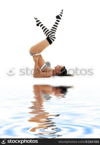 striped underwear girl practicing supported shoulderstand on white sand