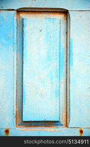 stripped paint in the blue wood door and rusty nail