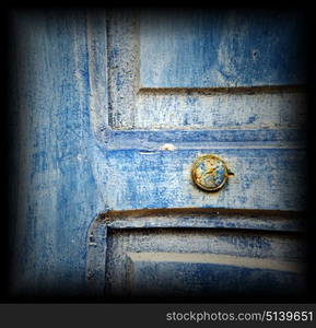 stripped paint in the blue wood door and rusty nail