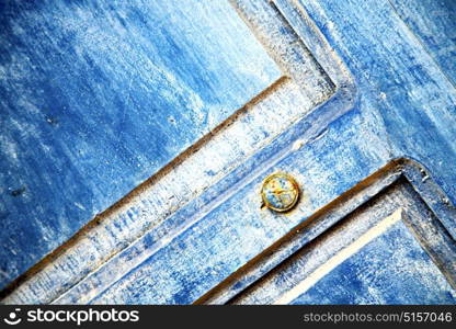 stripped paint in the blue wood door and rusty nail