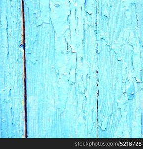 stripped paint in the blue wood door and rusty nail