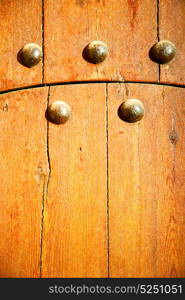 stripped paint in the blue wood door and rusty nail