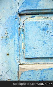 stripped paint in the blue wood door and rusty nail