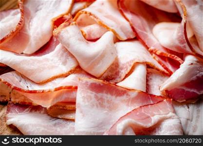 Strips of bacon. Macro background. Bacon texture. High quality photo. Strips of bacon. Macro background.