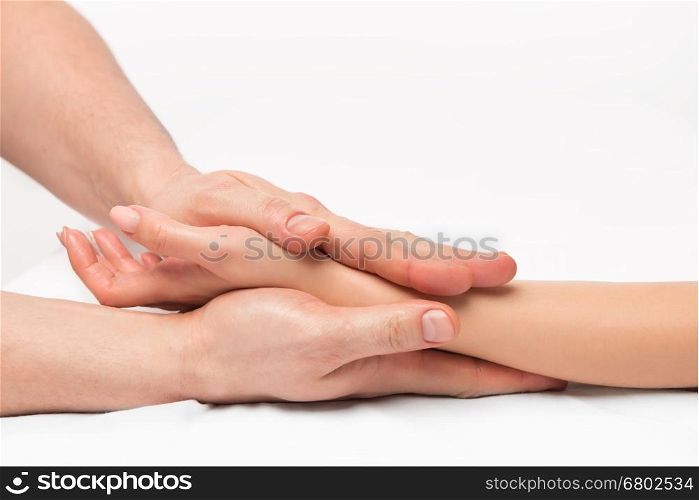 stroking massage of hands close up on a white background