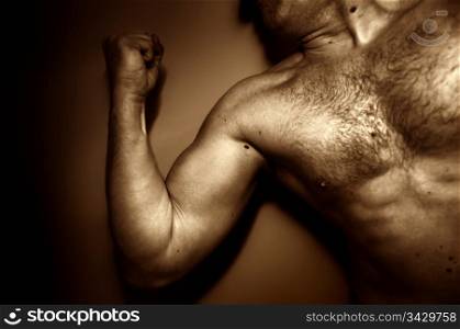Strong adult male showing his muscles, expressing emotions