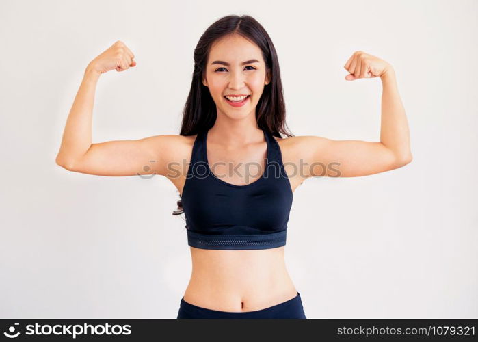 Strong and confident Asian woman in fitness gym. Healthy lifestyle concept.