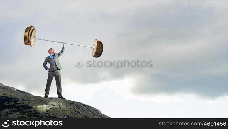 Strong and powerful. Confident businessman lifting above head barbell made of coins