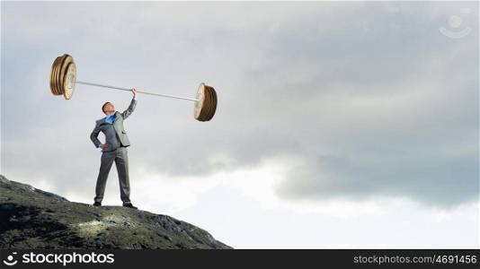 Strong and powerful. Confident businessman lifting above head barbell made of coins
