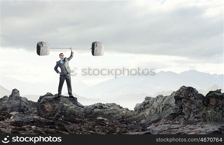 Strong and powerful. Confident businessman lifting above head stone barbell