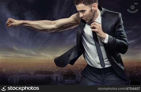 Strong and very muscular businessman over the city