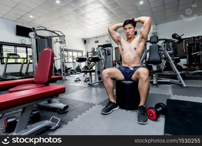 Strong Athletic Asian Man workout with dumbbell curl Concentration muscle upper arm for bodybuilding feeling so strong and powerful,Bodybuilder Concept