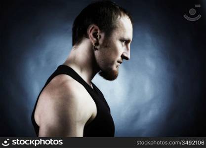 Strong athletic man on black background. Shooting in studio