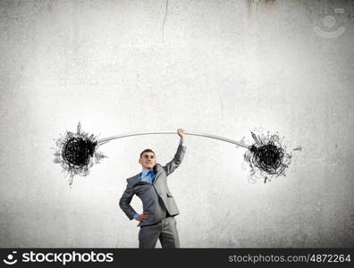 Strong businessman. Young strong businessman lifting barbell on one hand