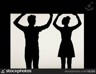 Strong couple holding the black ceiling