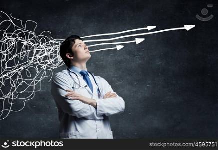 Strong decision making ability. Young man doctor on concrete background and thoughts coming out of his head