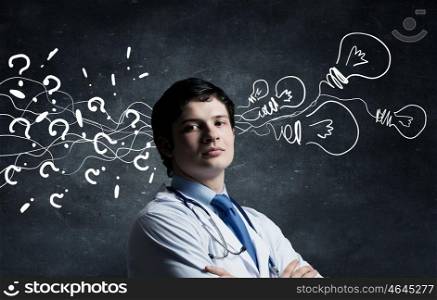 Strong decision making ability. Young man doctor on concrete background and thoughts coming out of his head