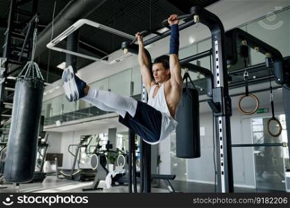 Strong energetic sportsman with perfect muscular body pulling up on bar at sport studio. Fit trainer doing full body workout and bodybuilding training exercise with gym equipment. Strong energetic sportsman with perfect body pulling up on bar at sport studio